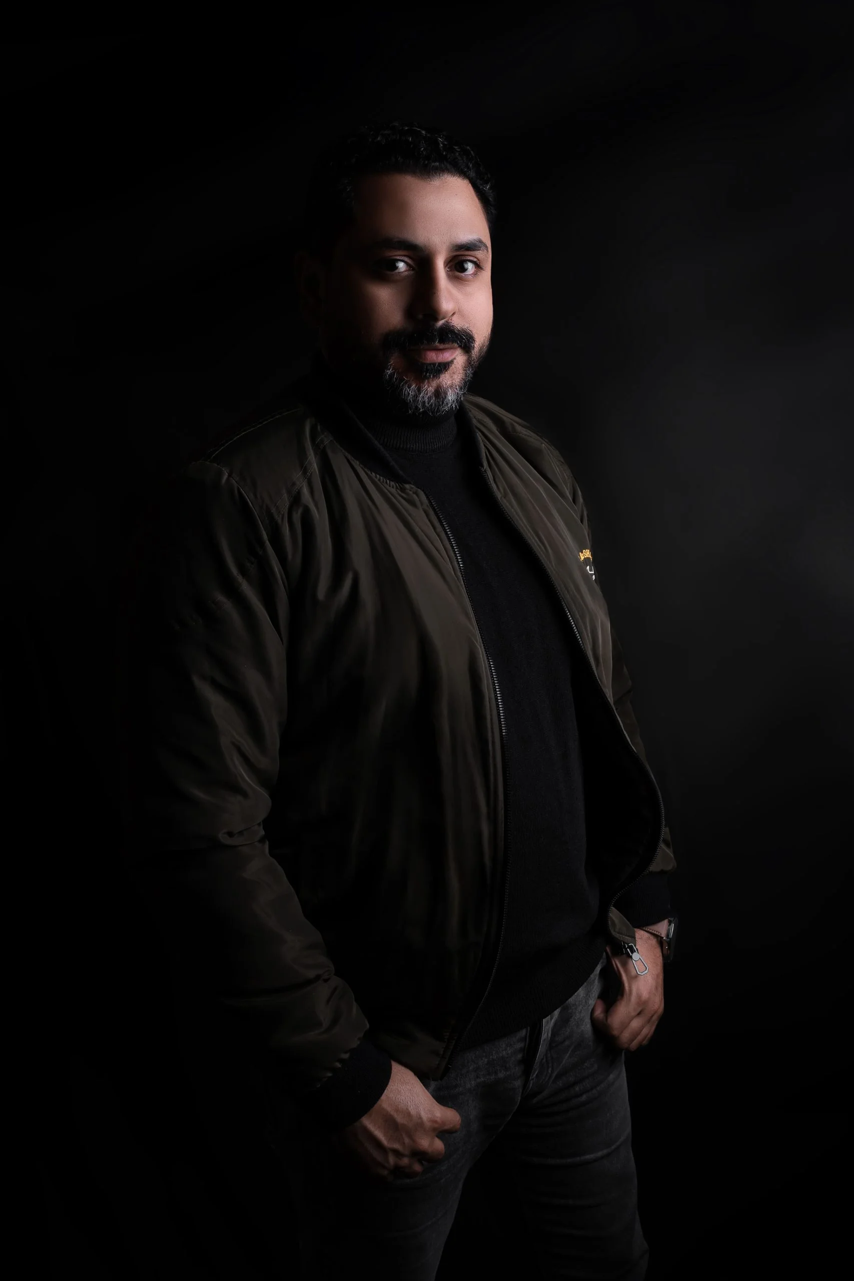 Ahmed Waheed Professional Portrait: A dramatic, professional studio portrait of a man with a beard. This photo represents his expertise in Brand Strategy and Art Direction. Suitable for executive leadership profiles.